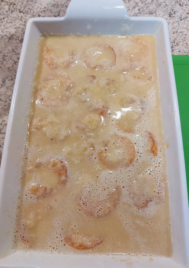 Apricot Clafouti batter over fruit